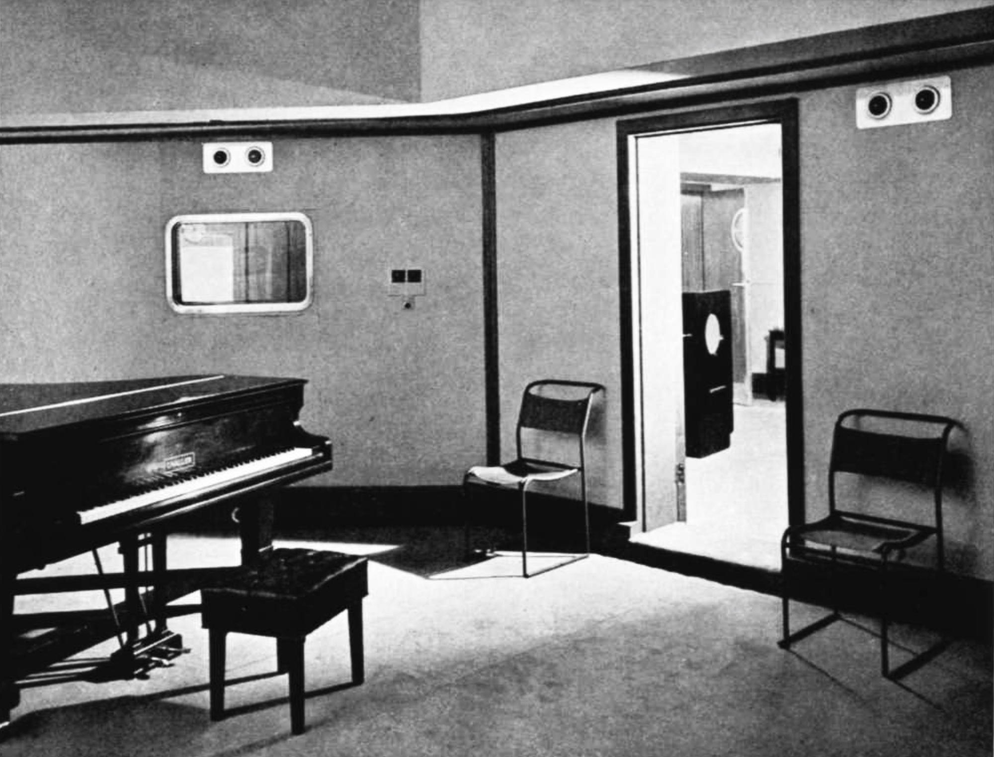 A small studio with a piano